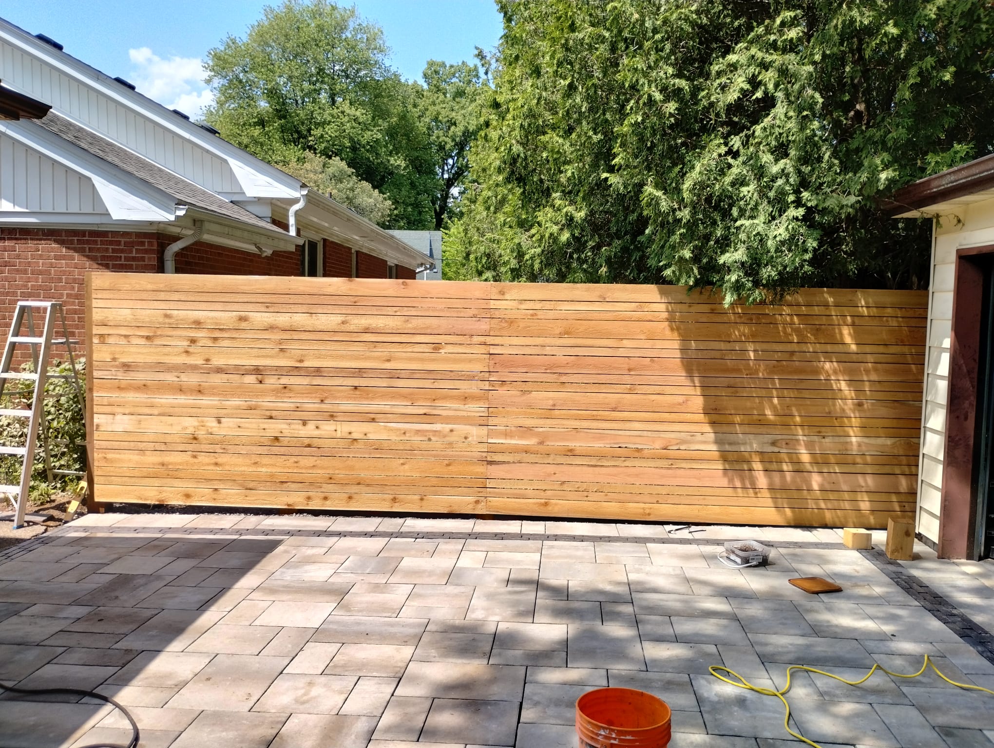 Backyard pavers with cedar privacy fence Ancaster