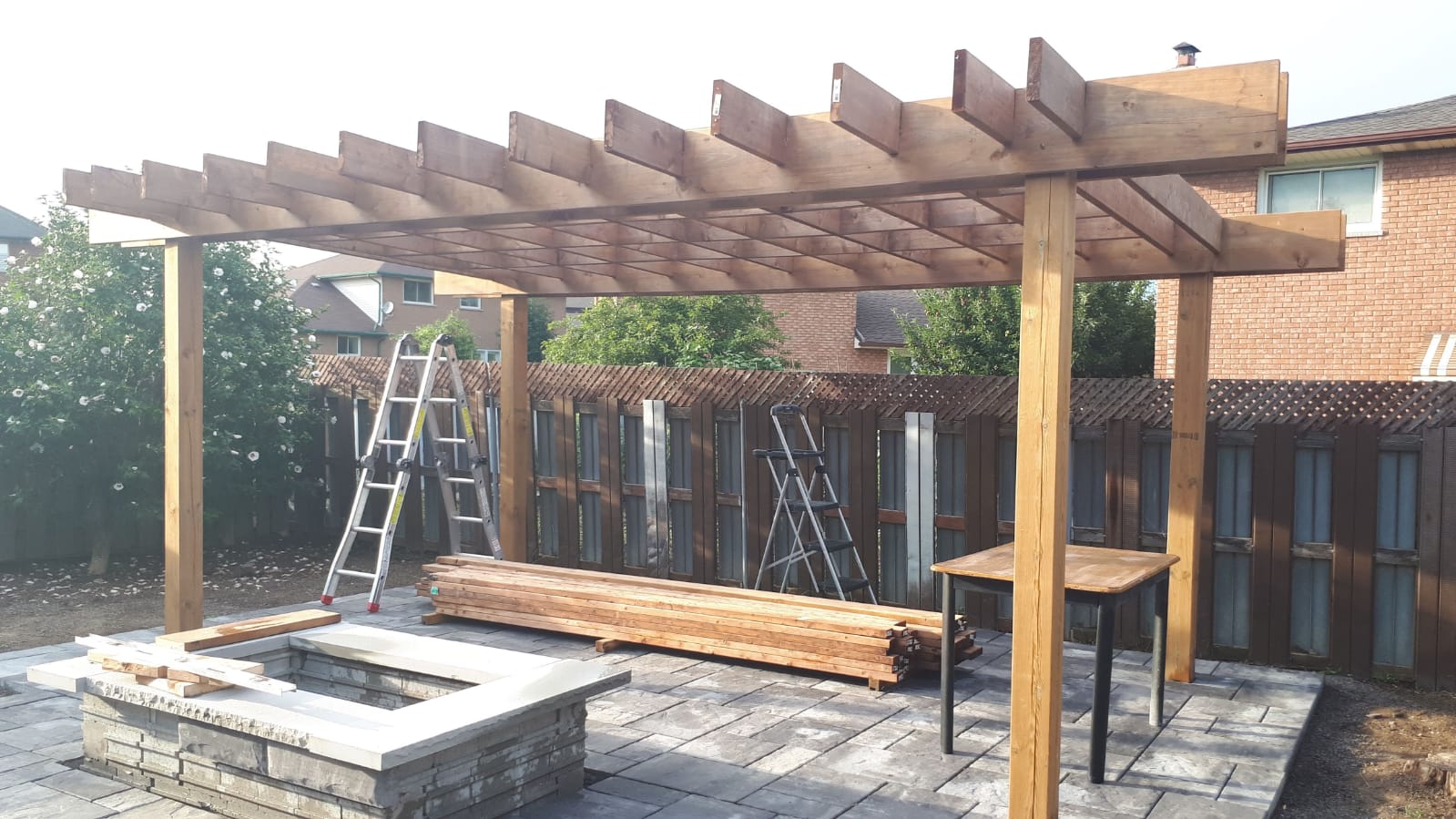 Backyard paver patio with pergola and fire pit Waterdown