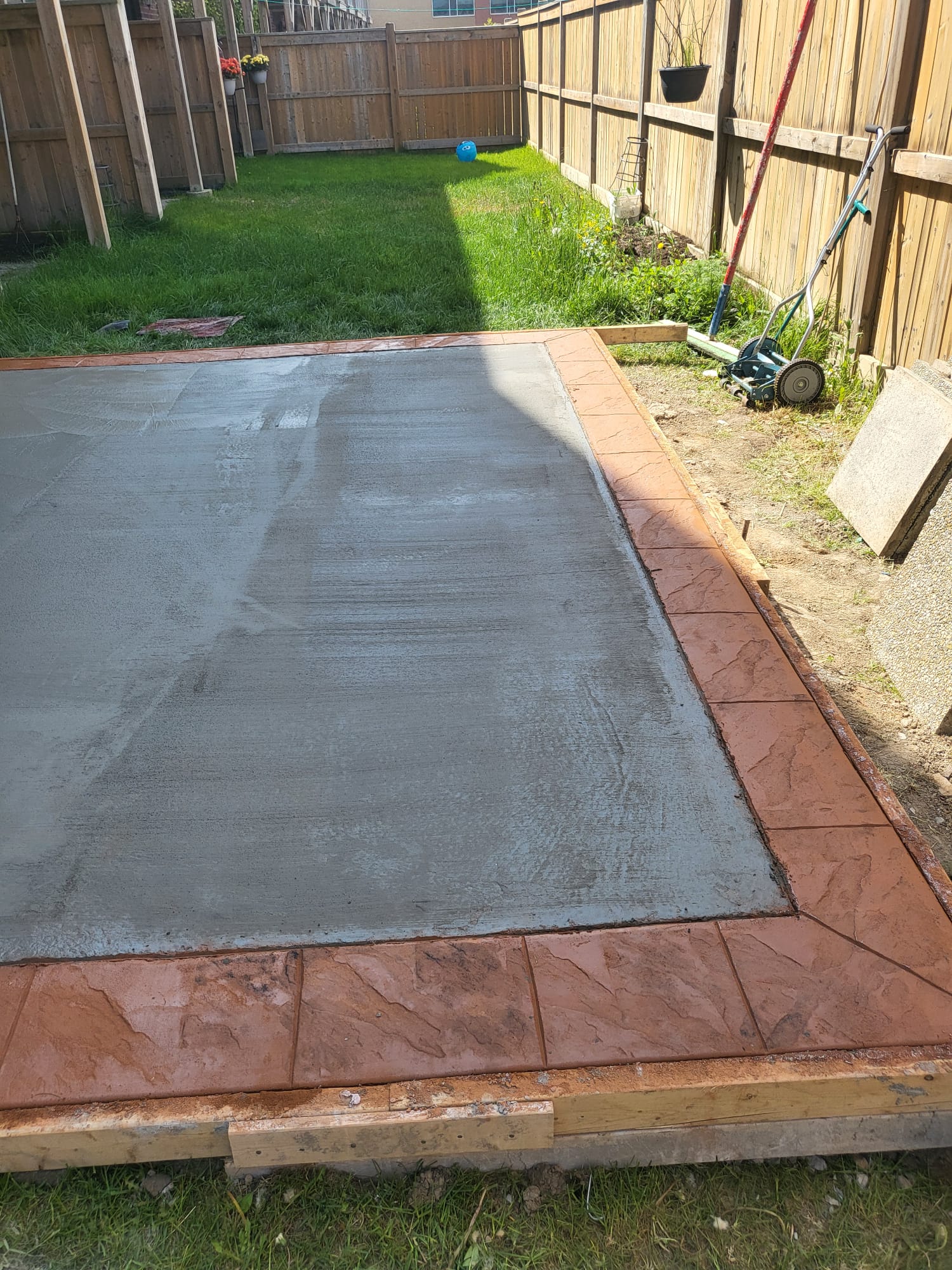 Backyard concrete patio with stamped border Oakville