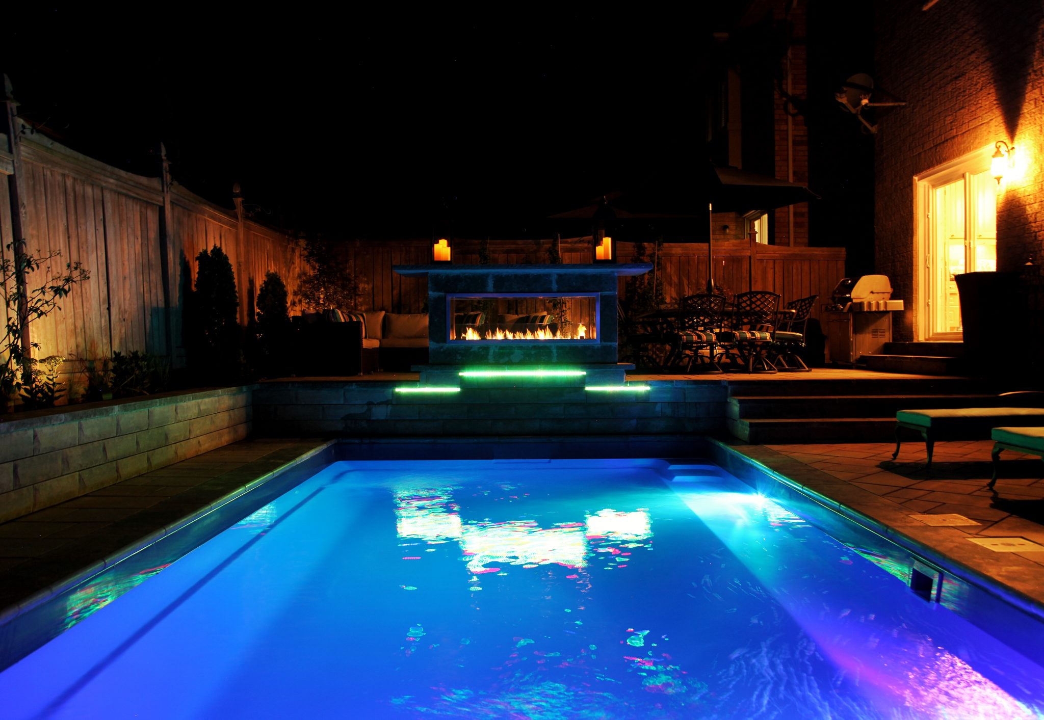 Finished backyard landscaping by Seven Stones  -  sod, planting beds, and hardscaping in the Hamilton region