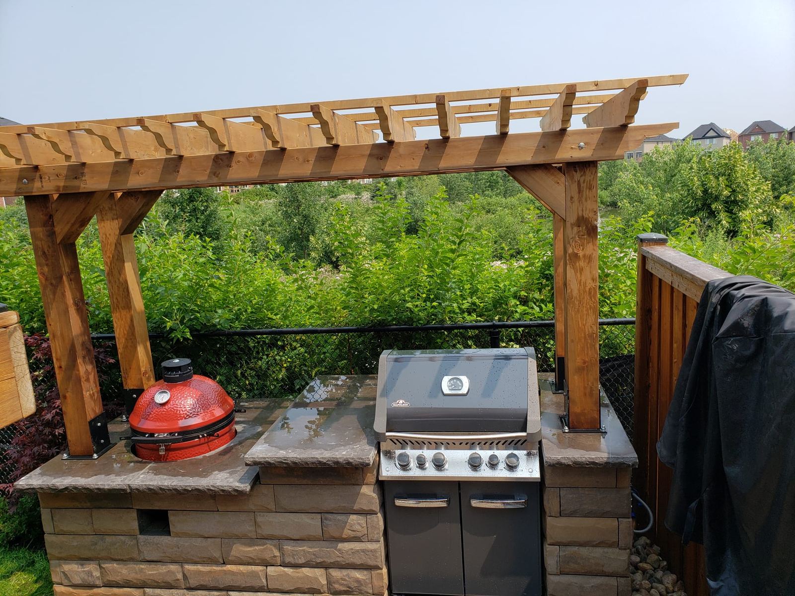 Outdoor kitchen with pergola and built-in BBQ