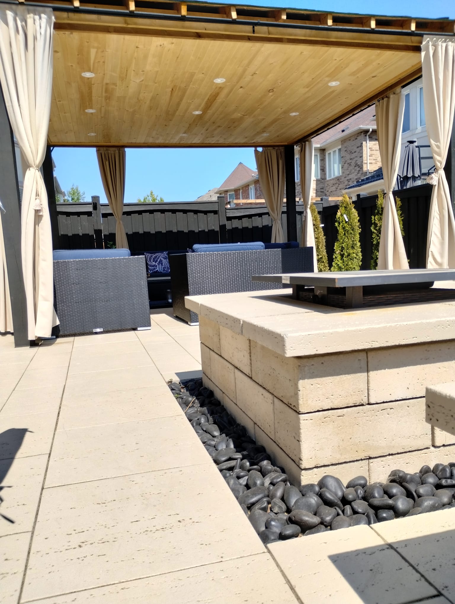 Backyard paver patio with pergola and fire feature Milton