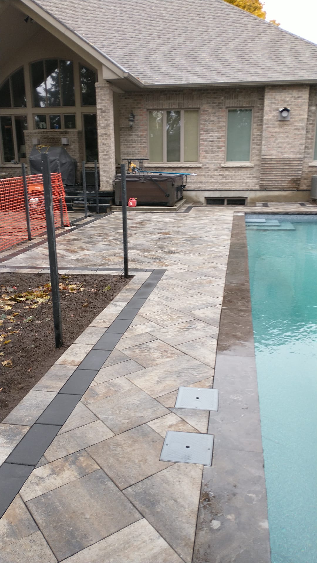 Pool deck pavers with charcoal banding installation Burlington