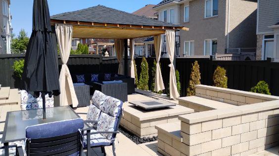 Paver patio with square fire pit installed in Dundas by Seven Stones Landscape